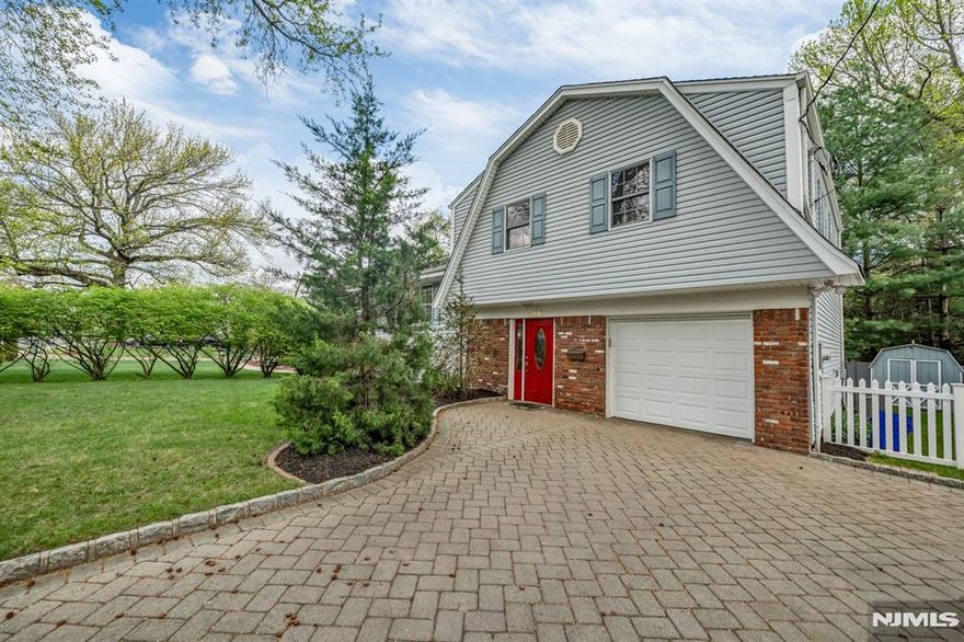 Beautifully renovated and meticulously maintained split-level home in idyllic Cresskill, offering 3 bedrooms and 2.5 bathrooms. This inviting home features a classic split-level layout designed for both comfortable everyday living and easy entertaining. The entry foyer leads to the ground level, where you will find a spacious family room with glass double doors, opening directly to the beautiful backyard, along with a renovated powder room, laundry room, and access to the attached 1-car garage. A few steps up, the main living level offers an open and airy flow between the kitchen, living room, and dining room. Gleaming hardwood floors enhance the living and dining areas, while the beautifully renovated kitchen is equipped with a center island, granite countertops, stainless steel appliances, and an open-concept design perfect for entertaining. The bedroom level features 3 spacious bedrooms and 2 full bathrooms, including a primary suite with its own en-suite bathroom. Additional highlights include central air, a 4-car driveway, and a lovely backyard with a paver patio. Do not miss this fantastic opportunity to own a move-in-ready home in one of Cresskillâ€™s most desirable locations.