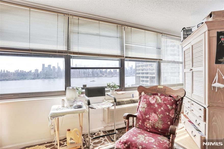 Donâ€™t Miss this Opportunity for a Spectacular View and Location in Tower 3! Experience stunning River and Manhattan skyline views from this beautifully updated one-bedroom condominium at the renowned Galaxy Towers. This home welcomes you with a foyer and powder room leading to a bright living/dining area, accented by track lighting and custom built-in shelves. The modern open kitchen boasts new stainless steel appliances and granite countertops. The oversized bedroom includes a private en-suite bath, large closet, and sun-filled solarium. Hardwood floors throughout add warmth and style. Enjoy full-service, resort-style living with a 24-hour attended lobby, state-of-the-art fitness center, and full spa with sauna, steam, and meeting rooms. Amenities include indoor/outdoor pools, tennis & pickleball courts, on-site shops, grocery store, restaurant, pharmacy, and dry cleanersâ€”plus the spectacular rooftop garden mini-park. Indoor parking available (fee). Pets welcome! Just steps away is James J. Braddock Hudson County Park, a 167-acre urban oasis with lakes, walking trails, sports facilities, and breathtaking NYC skyline views. Learn more about Galaxy Towers living https://www.thegalaxytowers.com/lifeatthegalaxy Maintenance includes all utilities except cable/internet. Excellent location with easy access to shopping, public transit, NY Waterway Ferry, and Light Rail.