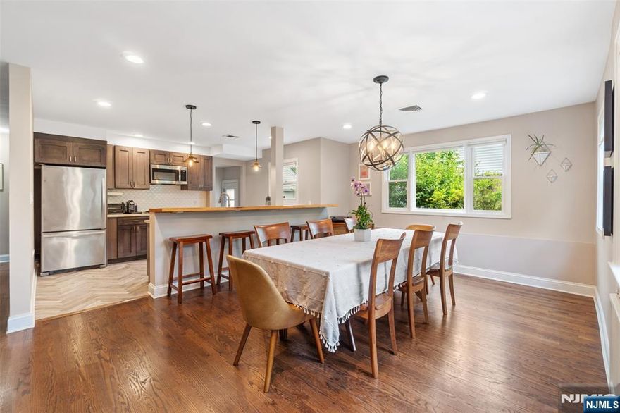 This spacious 4 bed, 2 bath home perfectly blends classic elegance with modern comfort. 2000+sqft. Upon entry you'll find a spacious living room featuring a beautiful bay window. The heart of the home boasts an open-concept living/dining area, creating an inviting flow for everyday living. The stunning open kitchen is a chef's dream, showcasing honed Taj Mahal quartzite countertops, stylish herringbone-laid wood-grained ceramic tile, and a suite of stainless steel appliances. You'll find elegant hardwood floors throughout the home, adding warmth and character. Enjoy year-round comfort with central AC. Each of the 4 bedrooms offers ample space, with the primary bedroom on the 2nd floor standing out as a true retreat. This private oasis boasts abundant closet space, a large WIC, and an ensuite featuring a jacuzzi tub and a stand-up shower. The home also benefits from a brand new roof for peace of mind. Outside, you'll find a detached 1 car garage and a driveway with parking for up to 4 cars. A washer and dryer are included for your convenience. The full-sized basement presents a fantastic opportunity to unleash your imagination and create additional living space tailored to your needs. Residents can enjoy local parks such as Mackel Park, the Matthew Feldman Nature Preserve and Teaneck Creek Conservancy for nature enthusiasts. For commuters, the 167 and 178 buses connect directly to the 42 St. Port Authority or the GWB Bus Terminal. This beautiful home is ready to welcome you!