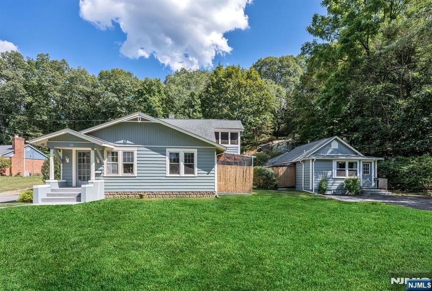 Rare Find - Two Homes on One Lot! Live in one & rent out the other, or use the 2nd as in-law suite or guest cottage, endless possibilities! The main home is full of charm, featuring beautifully refinished wood floors, classic moldings, & a unique, flexible floor plan. Step into a bright & inviting living room w/ a built-in bookcase (removable to expand the space into the adjoining room, currently used as a first-floor bedroom). The formal dining room opens to a three-season porch with side-yard access, perfect for relaxing or entertaining.Updated L-shaped eat-in kitchen offers convenient access to a fenced-in, covered patio, ideal for outdoor dining or enjoying nature year-round. First-floor laundry room & fully updated full bathroom (wheelchair accessible) add to the home's convenience. Upstairs, you'll find a spacious L-shaped primary suite complete with its own full bathroom & a private covered porch. The basement provides ample storage space. The 2nd home is a charming, self-contained 1-bedroom cottage featuring an open-concept layout with a combined living/dining area, kitchen, full bath, & access to its own private covered patio for relaxing or entertaining. The property boasts a large, private backyard, 1.5-car garage, and plenty of parking. Additional features include: separate utilities, 200 amp service, newer furnace. Conveniently located near schools, restaurants, & NYC transportation this unique property is a must-see! Security cameras in home