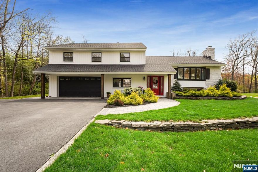 5-bedroom, 3.5-bathroom split-level home offers spacious living & luxurious finishes throughout. Open floor plan features gleaming hardwood floors, living room w/ gas remote start fireplace & mudroom w/ custom built-in cubbies. Gourmet kitchen is a chef's dream w/ high-end appliances, quartz countertops, marble herringbone backsplash & center island w/ seating. Dining area offers seamless access to the patio perfect for indoor-outdoor entertaining. Primary suite features custom walk-in closet & spa-like bath w/ dual vanities & walk-in shower. 3 addit. bedrooms share a main bathroom. Separate suite with its own entrance & open layout offers incredible versatility ideal for an in-law suite, home office or entertainment space. Finish the basement to give yourself even more living space. Outdoors, enjoy a large, level lot w/ a paver patio & built-in fire pit, perfect for gatherings. Located close to NYC transportation, top-rated schools, restaurants & shopping, this home truly has it all!