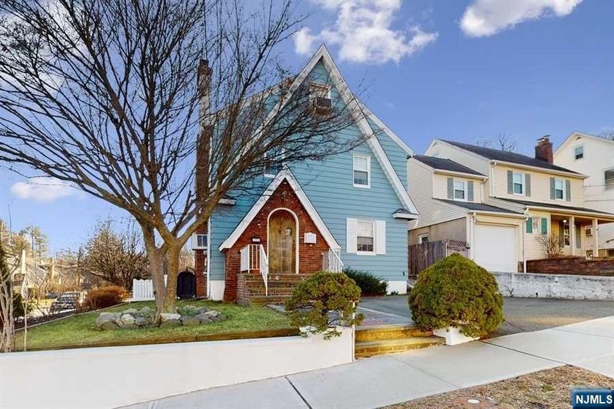 Stunning character, quiet street, true convenience! Beautifully maintained Colonial situated on a corner lot just 20 miles from Manhattan in the Upper Lourdes neighborhood of West Orange. Just few blocks to the Eagle Rock Reservation, close to schools, stores, restaurants & public transportation for an easy commute to NYC. This home has many charming details including stained wood trim & crown molding, rich wood floors & a warming fireplace with a carved wood surround, along with an updated kitchen & bathrooms. Large deck & patio perfect for entertaining, fenced-in backyard & storage shed. 2nd floor encompasses 3 generous-sized bedrooms, full bathroom, office. 4th bedroom on 3rd floor could also with multiple closets & large skylights windows offering an unobstructed view of NYC skyline. basement level includes a recreation room, full bathroom, laundry area, storage space & garage entrance. An attached 1-car garage, an additional exclusive paved area for extra parking.