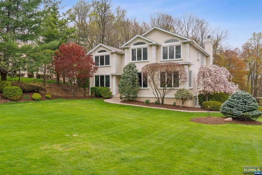 N Caldwell Classic Colonial beautifully situated on a cul-de-sac. The double width driveway leads to the three car garage with electric charging unit. This spacious 5 bedroom home with 4 full baths and 1 guest PR is awaiting your arrival. Enter into the double door grand entrance foyer. The entire home was freshly painted in today's colors, has sparkling wood floors, large rooms, open spaces - and so much more! A gas fireplace is a focal point in the Great Room which is perfect for large gatherings. The formal DR has stylized ceiling details and overlooks the landscaped rear yard lined with trees. Glass sliding doors open to the deck from the large Kitchen, with granite center island with seating, and another set of glass doors from the adjacent FR which has a wood burning fireplace. A dedicated Office, LR, PR complete the 1st level. The 2nd Level overlooks the Grand Foyer from the flex space Loft Area with built in window seats.