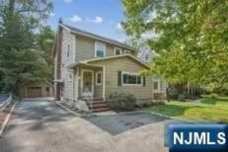 Welcome home to this very sunny 3 bedroom/2 bath Colonial! The first floor offers a spacious living room & separate dining room or potential family room with beautiful wood floors. Updated custom kitchen with granite counters & stainless steel appliances. A full bathroom completes the first level. The second floor has 3 bedrooms, main bath, walk in closet with new carpet & freshly painted throughout. Basement with walk out and laundry area. New French drains and sump pump with warranty. Oversized 1 car detached garage. Large level yard. Close to NYC transportation, shopping & major highways.