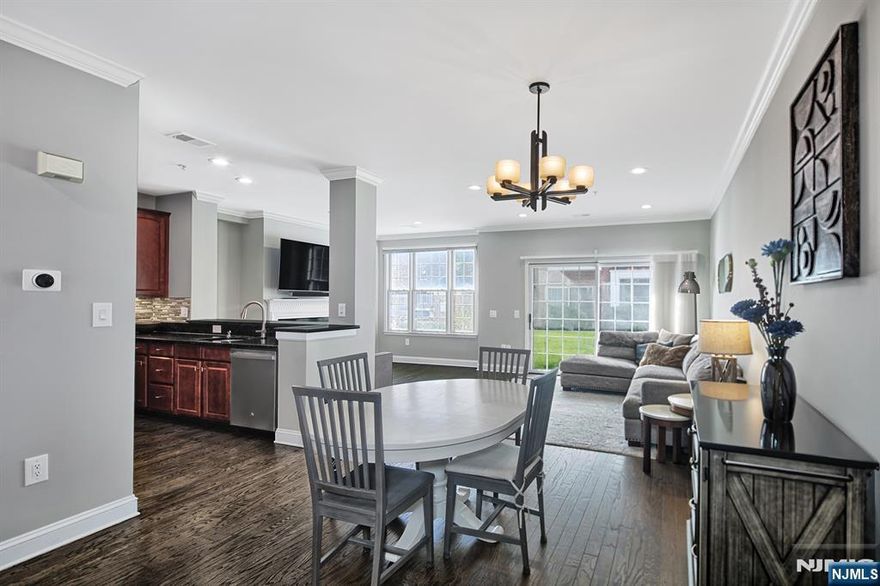 Experience refined living in this chic Bullâ€™s Ferryâ€“Bergenâ€“style corner home, ideally situated on a quiet cul-de-sac. The open-concept living and dining area flows seamlessly to a private patio through a glass slider, creating an inviting space for everyday living and entertaining. A private balcony extends from the primary bedroom, offering an additional outdoor retreat. Interior features include hardwood floors, a pull-down TV mount above the fireplace, and a beautifully updated galley kitchen with granite countertops, a custom backsplash, and stainless steel appliances. Thoughtfully designed closet shelving enhances storage throughout the home. The primary bathroom has been elegantly renovated with a new shower, toilet, flooring, and a Calacatta Quartz countertop. All bathrooms feature new mirrors, lighting fixtures, and hardware. Additional upgrades include new blinds on every window, updated electrical outlets and switches, and freshly painted doors with modern hardware. Smart-home enhancements include a Google Nest thermostat and Alexa-enabled light switches. Parking accommodates two vehiclesâ€”one in a private garage equipped with storage shelving and an EV charger, and one in the driveway. This sought-after community offers exceptional amenities, including two pools with Jacuzzis, tot lot, and free shuttle to the NY Waterway ferry and Light Rail. The 158 bus to NYC is just steps away, and the home is conveniently close to restaurants and shopping.