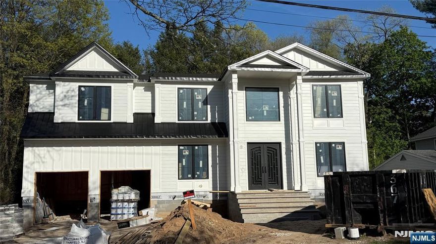 Luxury Living in the Heart of Paramus! Step into this exquisitely designed home offering the perfect blend of sophistication and comfort. The main level features a spacious Living Room, formal Dining Room, and a sunlit Eat-In Kitchen outfitted with premium stainless steel JennAir appliances. The Kitchen flows effortlessly into a dramatic two-story Family Room, creating an impressive space ideal for gatherings and entertaining. A stylish Powder Room and a private In-Law Suite add convenience and flexibility. Upstairs, the luxurious Primary Suite provides a serene retreat with elegant finishes. Three spacious Junior Suites offer privacy and comfort for family or guests, complemented by a conveniently located Laundry Room. The fully finished basement is a showstopper, complete with a custom Gym and a state-of-the-art Theater featuring a Half Bath. Throughout the home, custom carpentry showcases exceptional craftsmanship and adds distinctive character. Located in a prime Paramus neighborhood known for low taxes, top-rated schools, and proximity to shopping and transportation, this home truly stands out. Schedule your private tour today and experience upscale Paramus living at its finest! Owner has real estate license