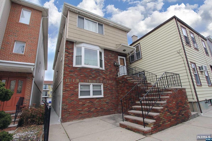 Large two family house with two generously sized apartments with 8 bedrooms and 3 full bath. 18 min walk to the Harrison PATH station, Red Bulls Stadium and redevelopment area. utilities are all separate. 3 Parking spaces in the back of the property. Close to public transportation, schools, parks, and shopping. Large finished above ground basement perfect for family events with summer kitchen. Property is located in HARRISON not E.Newark.