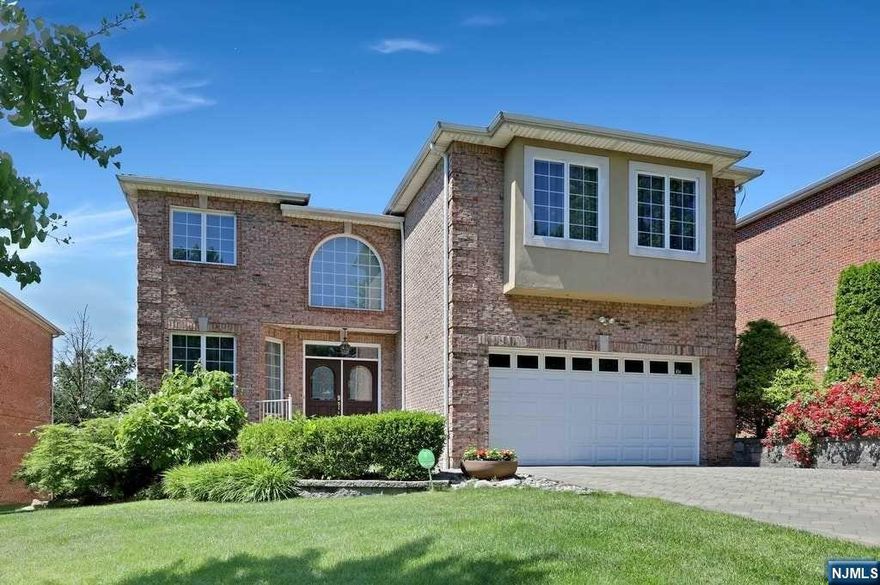VERY BRIGHT & LOVELY BRICK HOUSE. BEAUTIFUL ENTRY FOYER LEADS TO LIBRARY, FORMAL DINING RM, LIVING RM W FIREPLACE. A GOURMET KITCHEN W BREAKFAST AREA, TOP OF THE LINE APPLIANCES. GRANITE COUNTER TOPS/ISLAND. SLIDING DOOR TO LARGE DECK. 2ND FLOOR FEATURES MASTER SUITE W 2 WALK-IN CLOSETS, DOUBLE SINK BATH, WHIRLPOOL TUB. LARGE SIZE 2ND BR SUITE, 2 ADDITIONAL BRS N FULL BTH. HARDWOOD FLOOR THROUGHOUT. LAUNDRY ON 1ST FL. FINISHED LOWER LEVEL HAS FULL BTH N LARGE AREA CAN BE USED AS OFFICE, PLAY RM, GUEST RM, OR ENTERTAINMENT RM. MINUTES TO GWB AND NYC. WALK TO NYC BUS STATION.