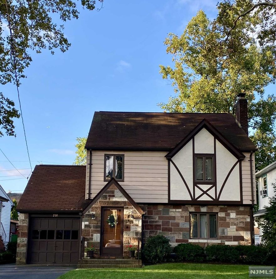 Fall in love with this picture perfect Storybook Tudor Colonial with amazing curb appeal. The Old English charm of this prime location home, circa 1937, begins with the decorative half-timbering, stone and stucco exterior, and continues through the original front door into the entrance foyer. Special highlights include gorgeous chestnut trim and inlaid hardwood floors. The spacious living room features a beautiful wood-burning stone fireplace with original custom cabinetry. The updated eat-In kitchen with breakfast room has granite counters, S/S appliances and is off the formal dining room. Enjoy morning coffee in the private screened porch that leads to the large level yard. King primary bedroom, two additional large BRs and full bath complete the second level. Central air. Walk-up stairs lead to full storage attic. Finished basement offers family/office space. The tree lined street is within walking distance to "The Boulevard" for NY transportation, shops & schools. A true gem