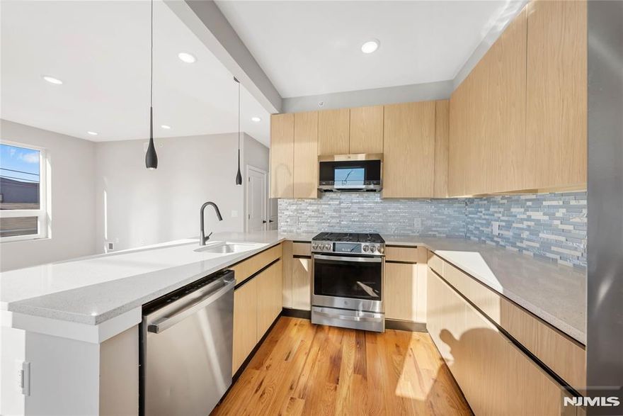 Stunning New Construction in Newark! Welcome to this ultra-modern 2BR home featuring high ceilings and sunlit rooms with ample windows that fill the home with natural light. The open layout highlights a modern chef's kitchen with quartz countertops, GE stainless steel appliances, pendant lighting, and plenty of cabinet space. Enjoy the added convenience of an in-unit washer and dryer, making everyday living even more effortless. The bathroom offers marble-style tile, dark gray flooring, and elegant black hardware for a luxury feel. Relax or entertain on the rooftop terrace with NYC skyline views, a rare perk in this area! Located just steps from Ferry Street's restaurants, caf s, shopping, parks, and major transportation, this home offers unmatched style and convenience. Parking is also available for residents, providing an extra level of comfort. A must-see for renters seeking modern living in a prime Newark location!