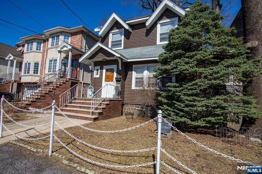 Never before on the market! This south facing colonial located on a 50 x 100 lot offers so many possibilities. High ceilings, hardwood floors, fireplace, natural woodwork, walk up attic and a two car garage are just some of the features of this home. Walk to school, shopping, dining and NYC transportation. This home won't last.