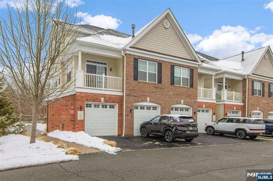 Stunning newer end unit townhouse in desirable Autumn Pointe, built in 2018, offering three levels of upgraded living space enhanced by the original owner. Large windows throughout this corner unit fill the home with natural light. Enter through a welcoming foyer with hardwood stairs leading to the main level, featuring two closets and a powder room. The open living and dining area boasts a soaring cathedral ceiling, highlighted by a gas fireplace. French doors open to a spacious deck overlooking a beautiful scenic view, perfect for morning coffee or evening gatherings. The bright white kitchen features stainless steel appliances, including a two year old refrigerator, white quartz countertops, subway tile backsplash, breakfast bar, and large pantry closet. The third floor offers a den overlooking the main level with a computer nook and potential for a third bedroom, as closet space already exists. The primary suite features a tray ceiling, walk in closet, and river views from the bedroom, with an ensuite bath offering a double quartz vanity, stall shower with quartz seat and glass door, and a linen closet. A full hall bath includes a granite vanity. The laundry room with full size washer and dryer also serves as a utility room. 2 zone Heat/CA. Convenient access to a deep one car garage with storage area and electric door. Close to NYC transportation, including Little Falls train station, and Montclair shopping and dining.