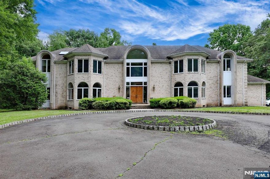 This stunning 7,200+ sqft estate is nestled on over 2.3 acres, providing unparalleled privacy in prestigious Saddle River. Set back from the road, this exquisite home offers a perfect blend of luxury and comfort. The expansive floor plan boasts 6 bedrooms, 6.5 bathrooms, and elegant, bright living spaces with high ceilings that flood the home with natural light. Walk into the impressive 2-story foyer where plenty of space to enjoy awaits. The large great room, billiards room, and dining room, along with a gourmet kitchen with a spacious island, are ideal for entertaining. Complementing these is a private office/library and a bedroom on the first floor. Enjoy serene views from the sunroom or relax in the luxurious master suite with a spa-like bathroom and balcony. The beautiful grounds with large patio provide ample space for outdoor activities. This home features an elevator and 3-car garage. Close to top-rated schools, don't miss this rare opportunity to live in Saddle River!