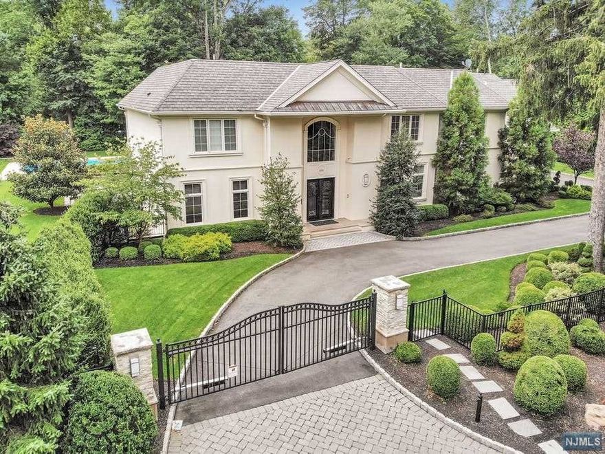 2015 Modern French inspired smart-house estate located on 1.2 acres with impressive front gates and mature landscaping on dead end street. The interiors are open, sunny and bright. Breathtaking entry foyer, handmade cherry office and large double living room with fireplace have views of the property. Open Chef's kitchen is the heart of the house with custom white glazed cabinets, white marble counter tops, Viking appliances and large eat-in area. Stunning 2nd floor Main bedroom en suite with granite fireplace, large dressing room and marble bath with additional 4 large bedrooms and laundry room. Other bedroom en suites located on the main floor and lower level. All bathrooms exceptional modern design. Lower level with family room, wet bar, wellness spa with gym, wine cellar and game room. Stunning and private out-door space includes large rolling lawns, modern designed pool with spa and multiple entertaining areas. Home can be sold furnished. Stunning home and minutes from NYC!