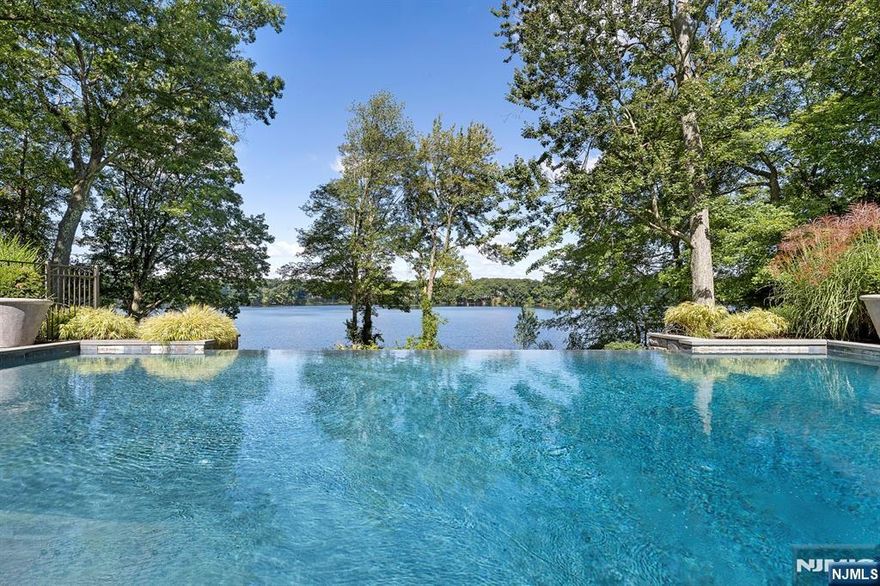 Located in the most distinguished neighborhood in South Gate section of Urban Farms. One of only 24 residences gracing Franklin Lake. This waterfront estate commands one of the most coveted positions-offering uninterrupted views across 100 shimmering acres. Architectural brilliance meets effortless luxury, where natural light, refined finishes, and flawless balance create an atmosphere of tranquility and grace. Crafted with the highest caliber of design and materials, the estate features 6 bedrooms and 10 bathrooms arranged across three levels, connected by a sculptural staircase and private elevator. The gourmet Clive Christian kitchen flows seamlessly to the breakfast room with fireplace,4-season porch, and lakefront deck. The Great Room dazzles with walls of glass, a full service bar, and captivating water views, while the cherrywood library offers warmth and sophistication.The Primary Suite is a sanctuary-featuring a marble & honey onyx spa bath, private balcony and coffee bar. The walk-out lower level is pure resort living: movie theatre, fitness room, golf simulator, guest suite, Summer kitchen and cabana bath. Outside enjoy the infinity pool, lake access ,BBQ pavilion, covered terraces and 4 car garage.6 fireplaces-every detail, pure perfection. This tranquil oasis is quintessential to the highest class of luxury living, built for those who hold style, design, and beauty in the highest regard.