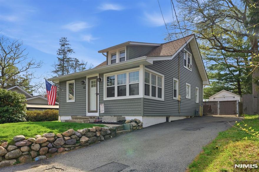 Charming Cape style home in the sought after Indian Lake community, offering the perfect blend of character, flexibility, and location. This 3 bedroom, 2 full bath home features a versatile layout with a first floor bedroom, living room, formal dining room, and an updated kitchen with stainless steel appliances. Two sunroom-style enclosed porch rooms provide additional living space ideal for a reading room, den or playroom in addition to the office. Enjoy outdoor living with a level, fenced in yard and large deck, perfect for entertaining or relaxing. A detached 1 car garage and full basement offer ample storage. Set on a quiet one way street, this home delivers both privacy and convenience. Located just a stones throw from Indian Lakes main beach with diving boards, as well as boat docks, the popular Indian Lake Bistro, and the soon to open Lakeborn Coffee window. Enjoy everything the lake lifestyle offers, including a clubhouse, motor boating, fishing, swimming, and year-round activities for all ages. Just minutes (or a short walk) to Downtown Denville with its vibrant shops, restaurants, and direct NYC transit, plus easy access to major highways. Prime location with a roof only 10 years old, an incredible opportunity to enjoy lake living in one of Denville's most desirable neighborhoods.