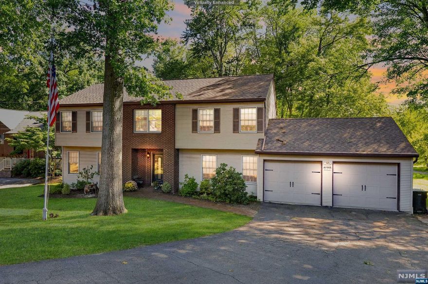 Situated on .38 of an acre this beautiful spacious colonial home, custom built for this original owner is set back in desirable Paramus. Enter to a large foyer with porcelain tile and two large coat closets, spacious dining room leads to an updated kitchen with quartz counters and stainless steel appliances, sliding glass door to a large two tier patio, large living room that is great for entertainment, family room with a fire place, powder room and laundry room. Second floor features three large size bedrooms, a main bath, master suite with recently updated gorgeous bathroom and a large walk-in closet closet. The finished basement has an office, a sitting area, storage and recreation space. Located near NYC bus, parks stores and Valley Hospital. Enjoy Paramus with great schools, low taxes and proximity to highways and NYC.
