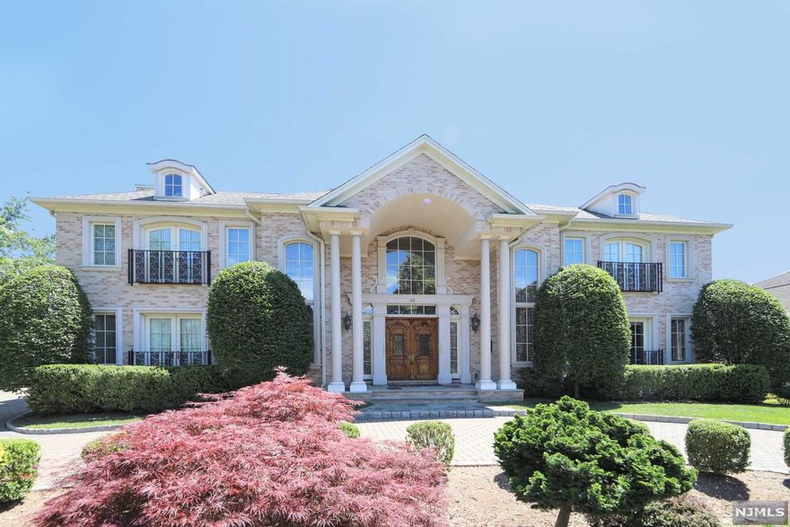 From the moment you enter the majestic two-story foyer with bridal staircase, you will be impressed by the incredible attention to detail. The first floor features a living room, elegant office, luxurious great room with fireplace, bright custom kitchen with top-of-the-line appliances, pantry, center island, breakfast room and adjoining dining room. The kitchen is equipped with a 6-burner stovetop, Subzero refrigerator & butler's pantry. Completing the first floor is an en-suite bedroom and powder room. The second floor features a master bedroom retreat with luxe bath and large closets, three additional en-suite bedrooms, a laundry room, and private sitting room with access to the balcony. The walk-out lower level includes a gigantic recreation room, tremendous theater, gym, full kitchen, two more en-suite bedrooms, and a second laundry room. Additional amenities include a pool, 2-car garage, and elevator to all 3 floors all within minutes to NYC.