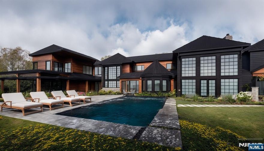 An unparalleled sanctuary of elegance and sophistication, 'The Cambridge Estate' is nestled on nearly 3 private acres at the end of a quiet cul-de-sac. Designed by Z+ Architects, this brand new home is estimated to be complete late 2026/early 2027. Enter through the front gates into a world of opulence across approximately 15,000sf with an elevator servicing all 3 levels, ensuring effortless accessibility. Car enthusiasts will enjoy 11-car garage parking. Inside, discover 6 sumptuous bedrooms & 7 full plus 3 half bathrooms, 3 fireplaces, show-stopping kitchen w La Cornue range and a 2nd prep-kitchen crowned by a 4,000-bottle wine room. Primary suite features dual WCs, separate vanity areas, 2 spa showers, infinity tub, & Himalayan salt sauna with integrated red light therapy. State-of-the-art gym & home theater. Outdoor pool pavilion with heated pool & spa, bluestone patios, outdoor kitchen, covered loggias & private tennis court. This estate is a statement of prestige & a testament to an unparalleled lifestyle.