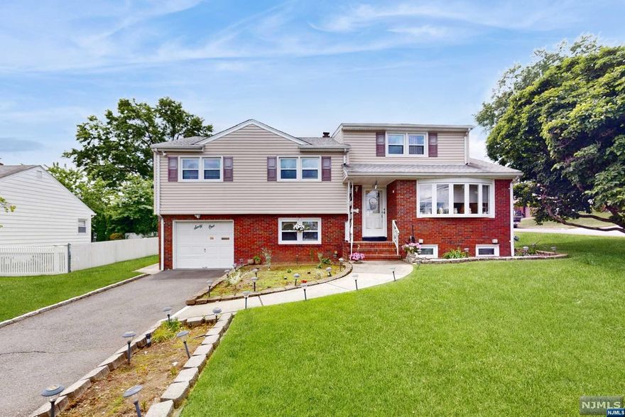 This beautiful split level home sits grandly on an oversized lot in a serene residential area. As you enter you are greeted by an open layout living room, followed by an oversized Eat-In-Kitchen with ample storage in like-new Birch cabinets and counter space. This expansive home includes 5 generous sized bedrooms (some with cedar lined closets) and 2.5 Baths. The ground level of this home offers a family room followed by a kitchenette with direct access to the backyard. This oversized home offers abundant indoor and outdoor space, making it a truly exceptional residence for those seeking comfort, functionality and charm in a residential setting. Minutes to Manhattan by car, bus or train.
