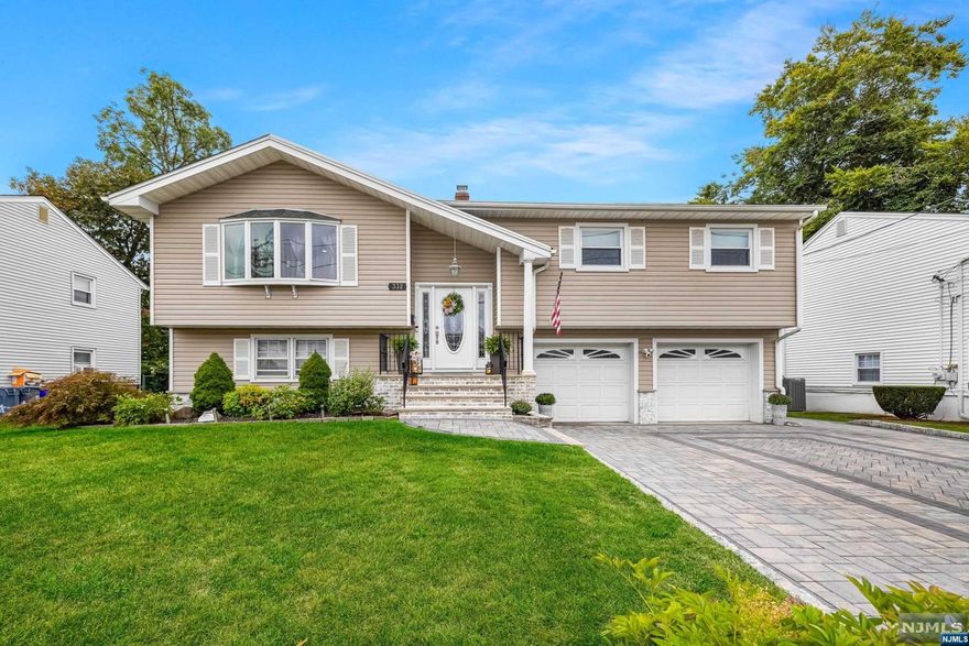 Welcome to this charming bi-level single-family home, perfectly nestled on a level 6,500 sq ft lot in a peaceful cul-de-sac location. With its great curb appeal, this home offers a warm and inviting atmosphere both inside and out. This spacious home features a total of 7 rooms, including 3 bedrooms, 2 full bathrooms, and 1 half bathroom. The bright and open kitchen has sliding doors that lead out to a newer deck, perfect for outdoor dining and entertaining. The ground-level family room offers a convenient walk-out to the fully fenced yard, providing seamless indoor-outdoor living. Additional highlights include, Central air conditioning and gas baseboard heating, A large two-car garage with ample storage space, Paver driveway, walkway, and patio that add to the home's modern aesthetic, A cozy fire pit in the yard, perfect for gatherings, plus a storage shed for extra convenience, hardwood and tile flooring throughout, this move-in-ready home blends style, comfort, and convenience.