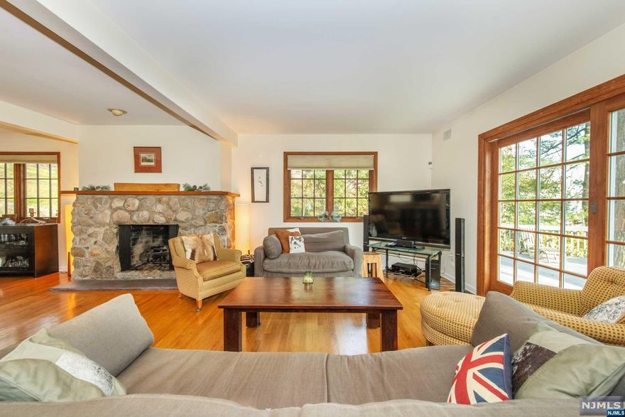 WOW! Look no further! Unique custom built home with breathtaking NYC skyline views! Wonderful open floor plan just perfect for easy living & entertaining! Spectacular stone fireplace flanking main floor, with wall to wall windows & decks offering solitude & relaxation.Tucked away up a private driveway is this very special gem.Grade level entrance from driveway opens to a first floor recreation room,storage area, utility room,powder room, & former photographer's darkroom, with additional options such as a wine cellar.Also offers inside entry to garage.Master bedroom with en suite bath with jetted tub & double sinks on main level along with powder room.Wolf stove in kitchen.Second floor boasts three additional spacious bedrooms,full bath, & coveted second floor laundry room.High ceilings throughout, many Pella windows,& lovely hardwood floors.Skylights bring in beautiful natural light.Just a hop, skip & jump to NYC trans & all that Montclair has to offer!A must see!