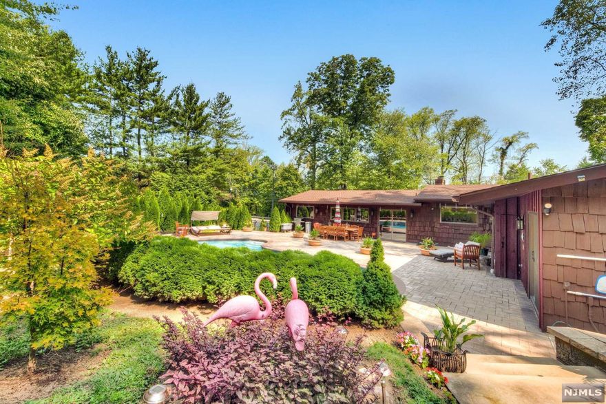 Sleek and beautifully appointed home, updated to perfection. Resort like backyard with in-ground pool, stone patios, waterfall with Koi pond and cabana with a half bath is the ideal setting for relaxation and entertainment. The first floor is spectacular. Light and bright. Wide open space in the kitchen with two center islands, Formal Dining Room, Living Room/ Den with sliding door to patio, Master Bedroom with Master Bath, two additional bedrooms and main bath completes this level. The lower level offers more-beautiful Family Room with fireplace, office, Bath, additional Bedroom/ Guest Rm with Bath, laundry. Convenient to anthing you need. Spectacular Home!