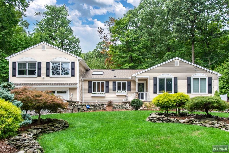 Picture perfect living in Lake Valhalla. Open floor plan, spacious rooms, hardwood floors and crown moldings are only some of the highlights in this custom expanded ranch. Gourmet eat in kitchen boosts granite counters, stone backsplash, stainless steel appliances, pantry and plenty of cabinet space. 1st floor master bedroom suite has tray ceilings, walk-in closet, master bath consists large walk-in shower, dual sinks and a linen closet. The full finished basement with 2nd family room and 2 additional rooms leaves plenty of space for office, gym and extra living. The large family room with wood burning stone fireplace has beautiful french doors which lead to the oversized Trek deck. The beautiful fenced in backyard with paver patio, covered grill station, stone flower beds and lush landscaping is perfect for outdoor entertaining. In walking distance to Lake Valhalla (membership optional), close to mass transportation, schools and great restaurants.