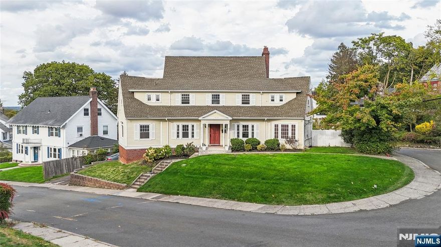 Welcome to 5 Park Road, an elegant residence gracefully positioned on a picturesque corner lot in Patersonâ€™s historic Eastside neighborhood, where classic architecture and tree-lined streets create a timeless sense of place. This 4-bedroom, 2.5-bath colonial blends traditional craftsmanship with modern comfort. Step through the inviting entryway and discover a spacious living area with hardwood floors and decorative details, leading into a formal dining room filled with natural light â€” perfect for memorable gatherings. A beautifully appointed office space, set just off a convenient half bath, offers flexibility for todayâ€™s work-from-home lifestyle. Upstairs, youâ€™ll find four generously sized bedrooms, including a grand primary suite with warm wood finishes and an expansive walk-in closet â€” a rare luxury in homes of this era. The full basement with an attached garage provides endless possibilities for a home gym, recreation lounge, or creative studio. Outdoors, the property showcases lush, landscaped grounds, ideal for entertaining, gardening, or peaceful evenings under the open sky. With its proud character and elegant proportions, this home offers both space and story â€” come and make it your next dream home.