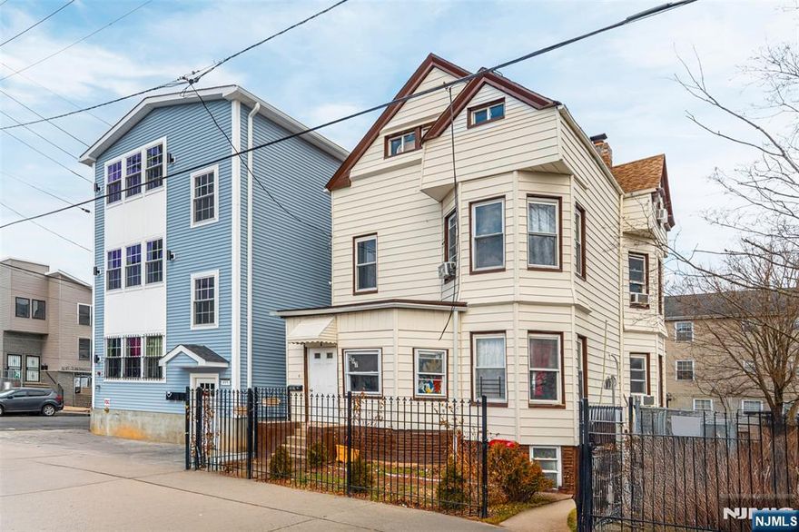 Check out your new home! This five-bedroom, two-bath home blends classic character with thoughtful updates across three finished levels, offering both flexibility and function. The first floor welcomes you with an enclosed front porch into entry foyer, to a large dining room and living room with high ceilings, large windows and plenty of natural light. A first floor laundry room/pantry adds everyday practicality. Continue into a spacious eat-in kitchen. Just off the kitchen, you'll find access to the yard. The second level offers three generous bedrooms and a full bath. A rear staircase provides direct access back to the kitchen a feature you don't see every day and one that adds convenience and flow. The finished walk-up attic expands the layout with two additional large bedrooms and another full bath, ideal for guests, work-from-home space, or multigenerational living. There is a full unfinished basement that includes a separate entrance, offering future potential depending on your needs. This home is situated on a quiet street steps to NJ Transit's Essex line and minutes to Route 280, Route 21, the Garden State Parkway and University Hospital. This home is a great choice for commuters who value accessibility.