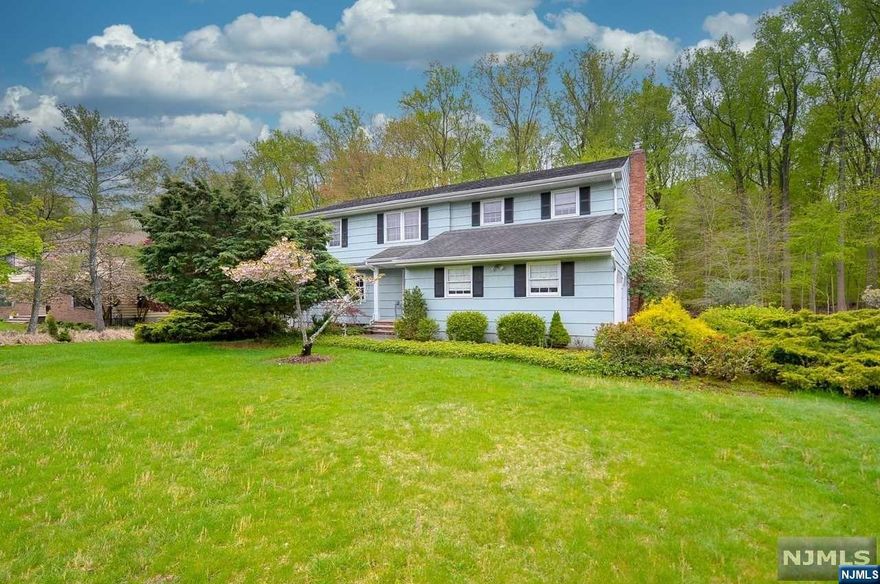 Classic center hall colonial situated on one of Harrington Parks prettiest streets. Property is 125 x 144 and the home boasts over 3700 sq ft. Entry foyer opens to large living room and entertainment sized formal dining room. Updated kitchen features custom cabinetry and granite countertops. Bright and sunny eating area with sliding glass door to deck and private rear yard. First floor 1/2 bath. Family room with lovely fireplace also features a sliding glass door to the deck. Upstairs features spacious primary bedroom with huge walk in closet and full bathroom. Three additional bedrooms all a good size. Full Bathroom. The basement is finished and features a bar, perfect for parties! The 2 1/2 bathrooms in this house are all updated in neutral tones. Well maintained and in move in condition this home is a must see to appreciate!