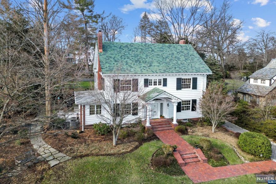 Exceptional Home, Premier Location! Stately Center Hall Colonial set high on .6 acres in Ridgewood's coveted Old Country Club section. Sophistication and old-world charm blend with a bright and rejuvenated interior at this 6 bedroom, 4 full/2 half baths home boasting 5,200+ SF of living space, 9-ft+ ceilings, and hardwood floors throughout. Living room w/ fireplace and French doors to the designated home office, and an open layout between a banquet-sized dining room and piano room flank the welcoming entry foyer. Great room sets the tone for indoor-outdoor flow with a wall of French doors to rear patio. Kitchen & powder room wrap up 1st level. All bedrooms are generously sized, including the primary suite w/ fireplace, walk-in closet, overlooking the lush, private backyard with a fantastic patio for entertaining, a basketball half-court, and 2-car garage. Surrounded by beautiful homes on one of the most sought-after streets in town - you don't want to miss this one.