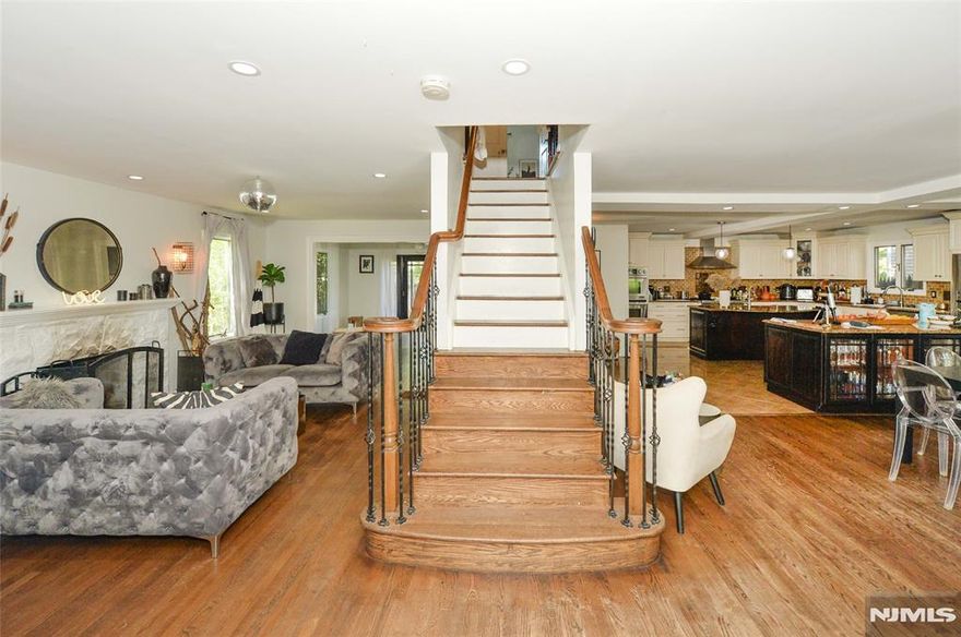 Step into timeless sophistication in this grand, oversized Center Hall Colonial, nestled in one of Teaneckâ€™s most coveted neighborhoods. Perfectly positioned just moments from houses of worship, top-rated schools, lush parks, and effortless NYC transit, this home delivers the ideal blend of convenience and prestige. From the moment you enter the sun-drenched double-height foyer, youâ€™re greeted by warmth, elegance, and a sense of arrival. The formal living room invites cozy evenings by the classic wood-burning fireplace, while the light-filled family room, framed by French doors, opens to a picture-perfect landscaped backyard with a patio designed for al fresco dining. The oversized kosher kitchen boasts double islands, double ovens, dishwashers, high-end premium appliances, abundant custom cabinetry, gleaming granite counters, and a striking brick backsplash, seamlessly flowing into the formal dining room. A chic powder room completes the main level with style and convenience. Upstairs, discover three generously sized bedrooms, a stylish full bath, and the primary suite of your dreams, complete with vaulted ceilings, a spa-like bath featuring a soaking tub, a walk-in shower, and double sinks, plus a custom walk-in closet. Work from home in the sunlit office offering flexibility and storage! You will also enjoy the versatility of an unfinished basement with endless potential, and take advantage of the laundry and half bath already in place.