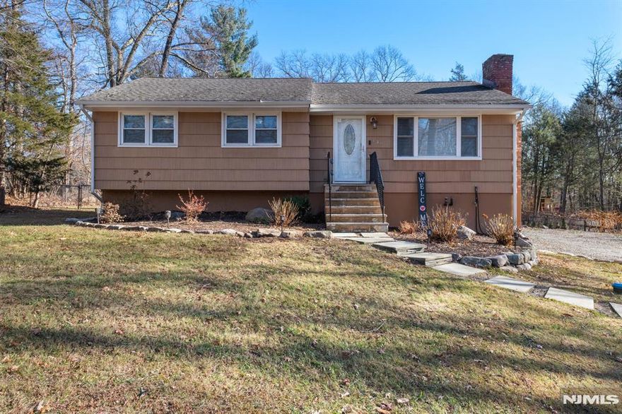 Move in ready. A surprising variety of living spaces from top to bottom. The bright and airy skylit kitchen with granite counters and stainless appliances looks out past the sliding doors to the oversized deck and back yard, over 300 feet deep, fenced and more private than one would expect being on a primary road. The living room has a wood burning fireplace and plenty of firewood in the way back of the yard. Two full bathrooms, one up and one down, along with a laundry room, utility room, lots of closets, even a pull down attic ladder provide tons of storage space. The walk out basement to the oversized driveway is from an extra room downstairs that is easy to bring back to the build-in garage the home started with. See the home and septic inspection reports, permit history along with title and the tax record card in the listing media.