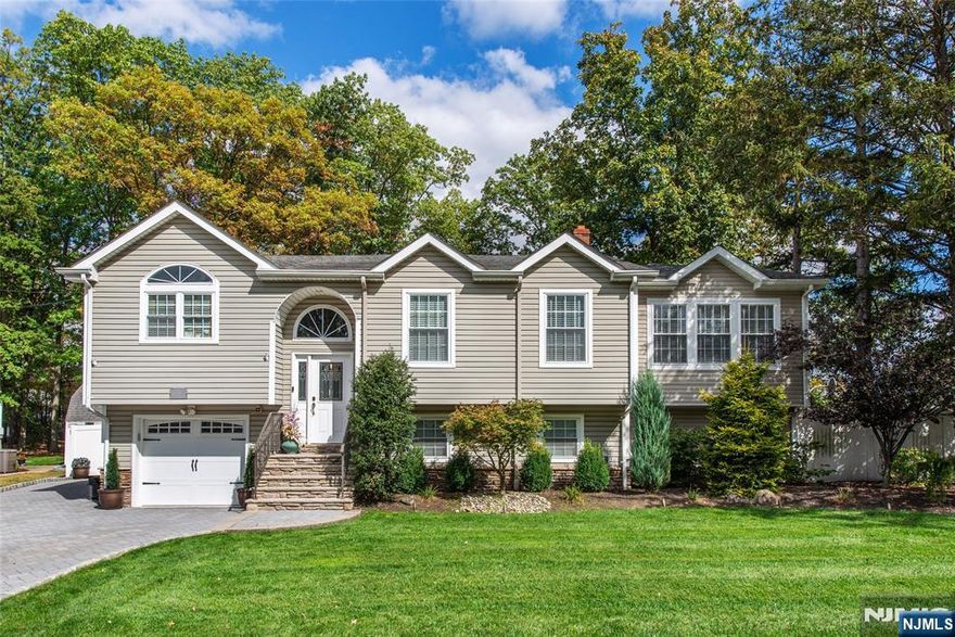 Welcome to this exceptional 4-bedroom, 3-bathroom home in the heart of Totowa, New Jersey. Thoughtfully designed for modern living and entertaining. This property combines style, function, and comfort. The main level boasts a bright, open living room, a formal dining area, and an updated kitchen with stainless steel appliances, granite countertops, and custom cabinetry. Gleaming hardwood floors flow throughout, adding warmth and sophistication. Key Features Second Kitchen: Perfect for an in-law suite, guest accommodations, or additional living space. Upstairs you will find generously sized bedrooms including Primary Suite: Spacious retreat with luxurious California closets and tons of natural light, Modern Spa Bathroom: Relaxing waterfall shower. Oversized Garage: Extra storage and workspace. Outdoor Living: Expansive backyard with outdoor kitchen and shed, ideal for entertaining. Location & Lifestyle Centrally located near shopping, dining, schools, and major highways, this home offers the perfect balance of convenience and suburban tranquility.