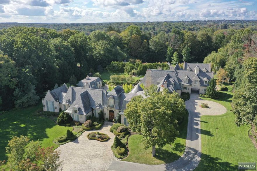 Set on 4.84 sculpted Versailles-Style Landscaped Acres, at the end of a quiet cul-de-sac, this architecturally spectacular 6-BR, 8.4-BTH Quintessential Estate features a glorious front to back oval Entry Foyer and Grand Vestibule w/hand-painted mural rotunda ceiling & custom 3-level circular staircase. The well-equipped Clive Christiansen Kitchen w/marble island, breakfast bar & raised hearth, opening to the expansive Great Rm w/antique FPL & arched beam cathedral ceiling, are made for memorable gatherings w/family & friends. Sumptuous front to back 1st FL MBR STE w/FPL; cherry and mahogany Billiard Rm w/FPL; and climate-controlled Wine Tasting Rm. European-themed LL w/Award-Winning Theater, French Cafe, Wine Cellar, Golf Simulation Rm & more. Outfitted w/Smart Home technology, elevator, security & radiant heat. Massive stone veranda w/BI BBQ/Kitch. Roman-shaped pool, spa & cabana w/FPL. 7-Car Garage. Tennis, basketball, chipping green, playground & too many amenities to mention!