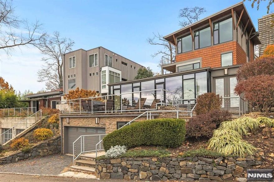 A great value in this sought after enclave and w/a house that hits all the marks: Contemporary, 4 bedrooms, 6 car parking, & views of the Hudson River, GW Bridge, and Manhattan. Situated on a large lot that spans from Colony Rd above (w/parking) to Annnet Ave below for a total of 6 car parking. This masterpiece was built on poured concrete that levels up the mountain like a stairway to heaven. Impeccable design throughout that captures the serene setting & views. The top floor MBR is divine w/ panoramic views, a deck, and Spa-inspired bathroom. The enormous patio on the main level leads to dramatic walls of glass that provide endless natural light within. Renovations such as a stunning newer kitchen has Cesar cabinets w/LED under lights, granite C. tops with a waterfall center island, Thermador appliances (Wi-Fi enabled), Kohler touchless faucet & new garbage disposal. Hearty & comfortable Virginia Mill Works HW floors throughout the entire house. Owner has a NJ RE Liscense.