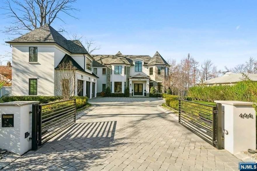 DRIVE THROUGH THE RING CONTROLLED GATES TO THIS HIGH END, LUXURIOUS 8000+ SF NEW CONSTRUCTION LOCATED ON THE PRESTIGIOUS EAST HILL OF ENGLEWOOD.FEATURING 7 BEDROOMS AND 6.5 BATHS..UPON ENTERING THE 2 STORY FOYER, YOU NOTICE 10 FT CEILINGS, HARD WOOD FLOORS AND CUSTOM TRIM THROUGHOUT, OFF THE FOYER IS A FORMAL DR W/WET BAR, OFFICE/FLR, A GR WITH GAS FIREPLACE THAT OPENS TO A CHEF KITCHEN W/CUSTOM CABINETRY AND 12' ISLAND WITH TOP OF THE LINE SUBZERO AND WOLF APPLIANCES, GUEST SUITE EN-SUITE BATH,.AND FINISHED 5 CAR AIR CONTROLLED GARAGE W EPOXY FLOOR AND STORAGE. GRAND STAIRCASE BRINGS YOU TO 2nd FL FEATURING PRIMARY SUITE W/SPA LIKE BATH & 550SF CUSTOM WALK IN CLOSET W/2 ISLANDS, 4 ADDITIONAL BEDROOMS W/WALK IN CLOSETS, 3 FULL BATHS,AND LAUNDRY ROOM. FINISHED BASEMENT FEATURES GYM,FULL WET BAR, THEATER,BEDROOM,FULL BATH. FULLY LIT UP EXTERIOR OFFERS LARGE OUTDOOR SPACE, MAGNIFICENT SUNSETS AND PRIVACY. ONLY 4 MILES FROM NYC. CLOSE TO TOWN, PLACES OF WORSHIP AND SCHOOLS.