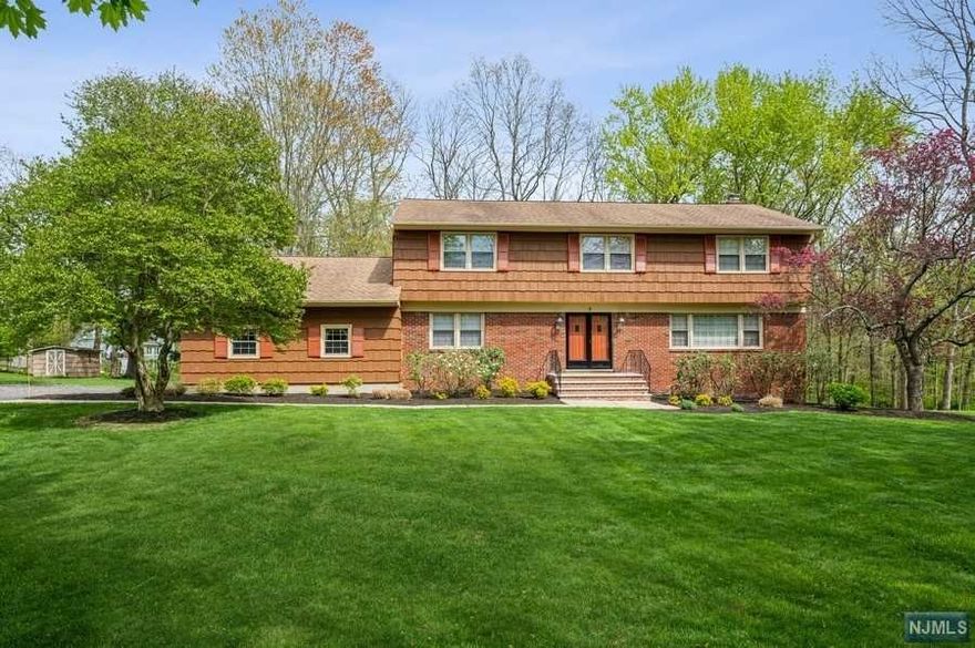 Spacious & spotless Colonial 5BD, 2 1/2 BTH is set on more than 1/2 an acre of manicured property on a desirably tranquil cul-de-sac in Morristown. Not far from an historic downtown, shops, rest & just minutes to the NJ direct train to NYC. A large foyer & warm hardwood floors greet you as you enter to the sunny & DR w/elegant crown molding & a chair rail. The large, bright kitchen is equipped w/granite counters, ample cabinet & counter space, a center island & a cozy breakfast nook. Step out onto the huge deck spanning the length of the house & overlooking the deep back yard & woods beyond. A spacious FR W/fireplace & another set of sliding glass doors to access the deck. A BD, powder room, convenient laundry room & access to the attached 2-car garage complete the floor. On the 2nd floor is the spacious primary BD suite complete w/ a walk-in closet & a full en suite BTH, along w/3 addt'l BDs & a full hallway BTH. The basement level offers loads of storage and vast possibilities.