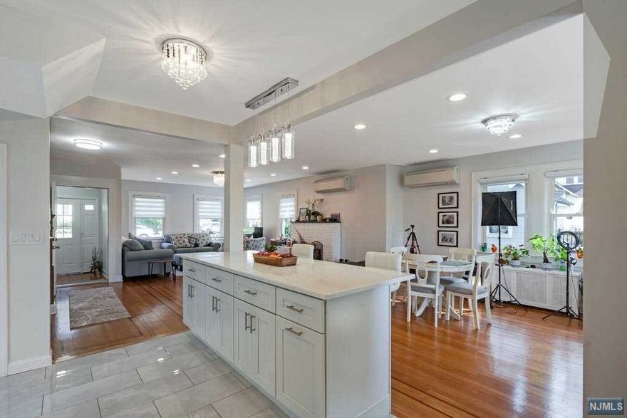 ABSOLUTELY STUNNING best describes this wonderfully updated sun-filled 4 bedrm-2.5 bath Colonial! Enter through the front vestibule w/ French doors & you will be immediately WOWED by the sophisticated open concept floor plan that beautifully marries together the liv rm w/ wood burning fpl, din rm & gorgeous gourmet center island kitchen w/ ss appls, quartz countertops, porcelain tiles! First fl laundry & half bath complete this level. Upstairs features the primary bedrm plus two add'l generously sized bedrms & a beautiful bathrm. There is also a 3rd level bedrm w/ closet & plenty of storage space. The basement features access to garage, another beautiful bathrm, lg storage rm & util rm. Other features incl hw floors w/ a beautiful inlay, ductless ac throughout. Two sets of glass drs lead to wrap around deck & spectacular garden w/ many specimen plantings & a peaceful koi pond. Wonderful tree-lined street, outstanding schools, easy commute to NYC & more! This home has it all!