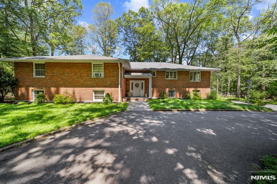 Fantastic Value in Franklin Lakes! Set on 1.7 private, wooded acres, this 4,500+ sq. ft. all-brick raised ranch offers incredible space, solid construction, and privacy in one of Bergen Countyâ€™s most sought-after communities. From the moment you arrive, the homeâ€™s inviting presence and generous proportions capture your attention.Step inside to a spacious layout designed for both comfort and entertaining. The oversized living room, complete with a wood-burning fireplace, flows seamlessly to the formal dining room and modern eat-in kitchen featuring granite countertops, center island and stainless steel appliances. Three large bedrooms include a primary suite with two double closets, a walk-in closet, and a private bathâ€”your personal retreat! A warm and inviting den with its own fireplace and custom built-ins provides the perfect space for relaxation or for remote work or study.The walk-out lower level is perfect for entertaining or multi generational living. This space offers a family room with a wood-burning fireplace, built-in wet bar, office, full bath with saunaâ€”and French doors to the back patio. Hardwood floors, three fireplaces, and a three-car attached garage add both charm and convenience. A rare opportunity to customize and create your dream home today! Driveway entrance off Rt. 208 N only, before Ewing Ave exit (between Guardrails). GPS may be inaccurate.