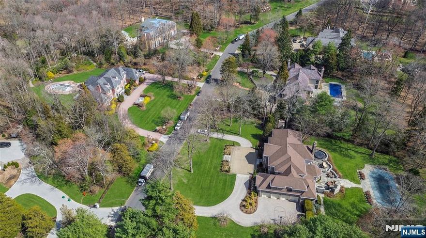 This exceptional estate is on a prime Saddle River location, offering a lifestyle where luxury & convenience meet the quiet confidence. A circular drive leads to a stately entrance and a grand 2 story foyer, highlighted by a sweeping staircase and carefully curated details. *NEW ROOF 2021, BOILERS 2022, HOT WATER TANKS 2024, Front Yard Landscaping Renv 2022 * * THE MAIN LEVEL is thoughtfully designed for both elegant entertaining and everyday living. Formal spaces transition seamlessly into a richly appointed library w/fireplace, while the dining room flows into the kitchen. The great room is filled w/natural light and anchored by a fireplace, creating a warm yet elevated setting. The kitchen is outfitted with a large center island, custom cabinetry and sunlit breakfast gallery overlooking the grounds. A guest bedroom, full bath, powder room, laundry room, second staircase, & access to a 4 car garage complete this level. * * THE 2nd FL offers a spacious primary suite w/a private sitting area, 2 walk in closets, & a well appointed bath featuring a double vanity, soaking tub, & separate shower. 4 additional bedrooms, each with ensuite baths and walk in closets, are thoughtfully arranged w/an additional staircase for convenience. * * THE LOWER LEVEL presents Golf swing suite w/lg glass gallery, expansive space for recreation, media, fitness along w/a full bath & generous storage. * * OUTDOOR LIVING is equally impressive w/custom patios, a heated pool, spa, and outdoor kitchen.