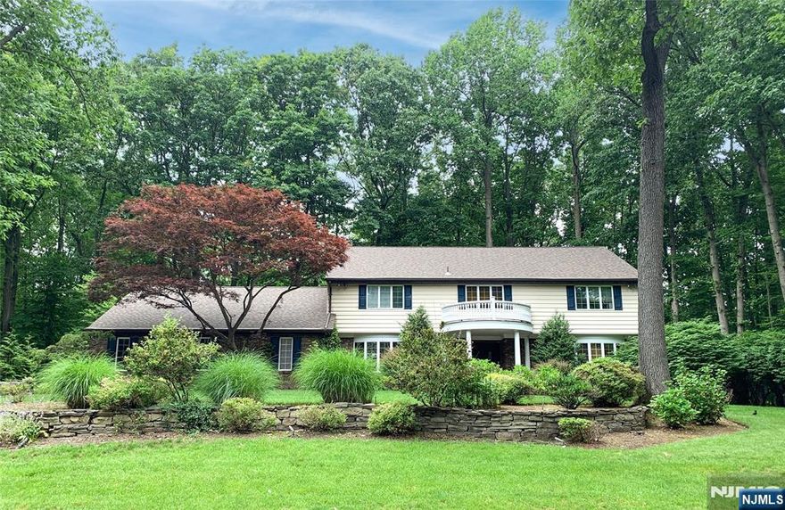 Welcome home to this stunning 5 BR 4.5 BA Colonial on the Hill in the most exclusive neighborhood in WCL. Boasting over 4800 sq ft of living space on .7 acres. Elegant foyer opens into large LR & DR w/custom millwork, oversized chef's kitchen w/subzero & center island, breakfast rm w/skylight, exquisite Great Room w/vaulted ceiling, skylights & stone fp flowing seamlessly onto deck & private yard, perfect for relaxation & entertaining. 1st fl is complete w/office, guest BR & full BA, powder rm & laundry. 2nd fl is thoughtfully designed w/primary suite w/spacious walk in closet & spa like bath w/heated fl, 3 addl generously sized BRs & full BA w/jetted tub & heated fl. The renovated basement features a rec room, home gym, wet bar, full bath, storage & cedar closets. This home presents a rare opportunity for sophisticated living in a premier neighborhood conveniently located near NYC, top rated schools, shopping, houses of worship and GS Pkwy! 2 New AC Units, New Furnace, Newer Roof.