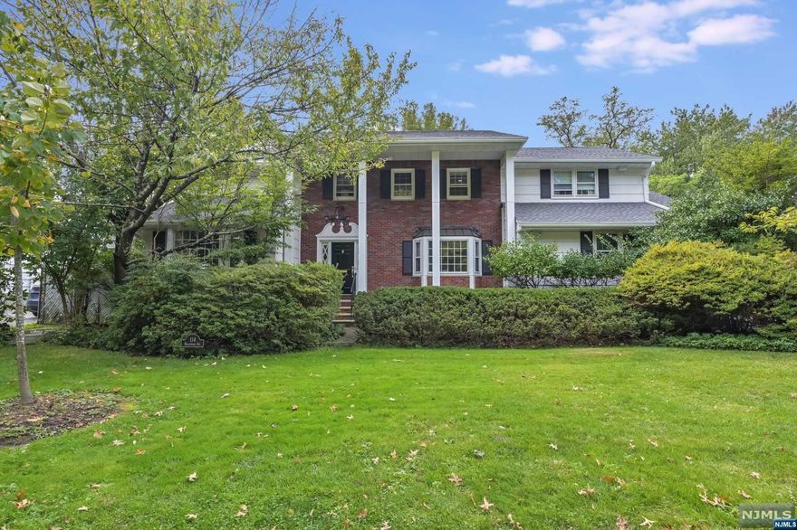 Impressive North Cliffs Center Hall Colonial offering beautifully proportioned and appointed rooms, welcome to Hollywood Avenue. Featuring a large and elegant living room that leads in to the spacious family room with gas fireplace, a custom designed kitchen with a Viking stove, double oven and Sub Zero fridge, bedroom, formal and bright dining room with two beveled glass french doors, laundry and full bath complete the first floor. The second floor boasts a large primary suite with a dressing room and three additional oversized bedrooms. There is a fully finished basement with a separate entrance, recreation room, gym and office and there is an abundance of storage throughout. Recent upgrades include a new roof, two zone central air, 2 car garage and parking for four cars. Relax on the deck in your private yard. All of this within minutes to GWB, fine dining, town parks, tennis courts, recreation and a short walk to North Cliffs School and NYC transportation.