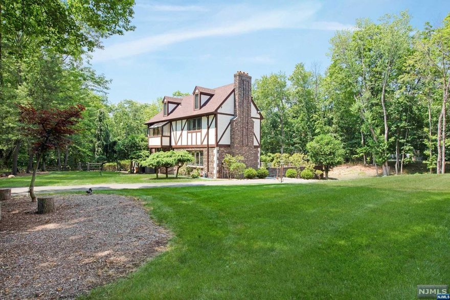 Welcome to the prestigious town of Saddle River! A magnificent, sunny Colonial Tudor Style home sits on a spectacular 3-acres property featuring five bedrooms, three full baths, two half baths, 2-story curved wall dining room, brass railing, Family room w/ fireplace, bedroom, laundry Room, 2-powder rooms and 3-season porch. A huge kitchen w/ a curved wall of windows bringing lots of light. Second floor accommodates a primary bedroom suite w/ three addition spacious bedrooms and a full bath. Lower level walkout w/ full bath access to the gunite pool/new motor. Many updates, New roof, gutters. New AC, New well system, New washer and a tremendous amount of landscaping front and back. Of course, don't forget the low taxes and the blue ribbon school. Only 30 miles from NYC. Property extends into to the Saddle River. NEW SEPTIC! A bright Colonial Tudor Style home with many updates. New Septic! Call Helen Martino @ 201-615-5188 for showings.