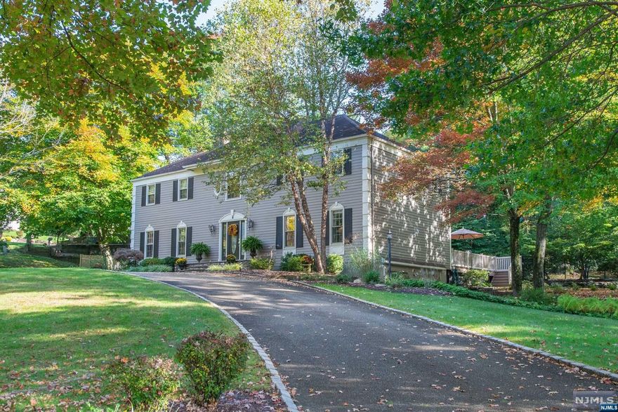 Unwind in the peace and tranquility of this spectacular 4BR, 3.1BTH CHC elegantly perched on nearly an acre of beautifully landscaped grounds. Located in a cul-de-sac on one of the most desirable streets in Roseland! Gourmet chef's kitchen features custom wood cabinetry, granite countertops, center island w desk, pantry, 6 burner s/s Wolf oven, custom wood-paneled Sub Zero refrigerator, Miele dishwasher, wine refrigerator, wet bar. The Great Room features magnificent wall of windows overlooking private outdoor oasis. Multiple sliders & French doors provide access to expansive blue stone patio & multi-level decks-great for outdoor entertaining. First floor features entry foyer, LR, DR, Laundry Room, cozy Family Room w gas FP & wood beams. Hardwood floors PLUS crown moldings throughout. Master Suite w sitting area, 2 walk-in closets. Gorgeous Master Bath w vaulted ceiling, jetted tub, double vanity, steam shower. Finished basement w rec room, full bath and offers in law capability.