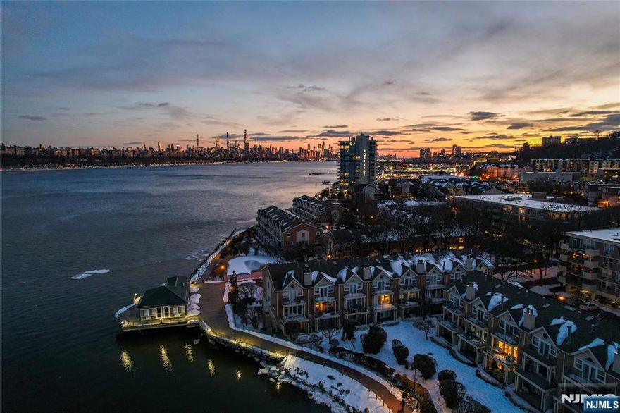 Impeccably updated 3-level townhome in the gated waterfront community of Grand Cove in Edgewater with NYC views! This residence has been extensively renovated and enhanced with high-end finishes, offering a truly move-in ready experience with every detail thoughtfully executed. The designer kitchen showcases stainless steel appliances, Quartz countertops and custom cabinetry, flowing seamlessly into the open concept living and dining areas. A fireplace anchors the living room, while the large southeast-facing terrace fills the space with beautiful natural light. The primary suite offers its own private terrace and a spa-inspired ensuite bath featuring a Kohler Air Bath spa tub, frameless rain shower, RH hardware and Toto washlet. The second bedroom includes its own full ensuite bath. Laundry is conveniently located on the bedroom level. Custom built closets maximize storage throughout. The ground level provides an expansive family room with walkout patio, easily functioning as a third bedroom or flexible living space, complete with a rare full third bathroom unique to this layout. Rich hardwood flooring runs throughout the home. HOA includes internet and cable. Community offers NYC views from the pool, 24/7 gated community with package storage and clubhouse rental with Manhattan views. Exceptional location directly beside Whole Foods and the #158 bus to NYC and shuttle bus to ferry terminal, with Mitsuwa, Trader Joeâ€™s, shops and restaurants just minutes away.