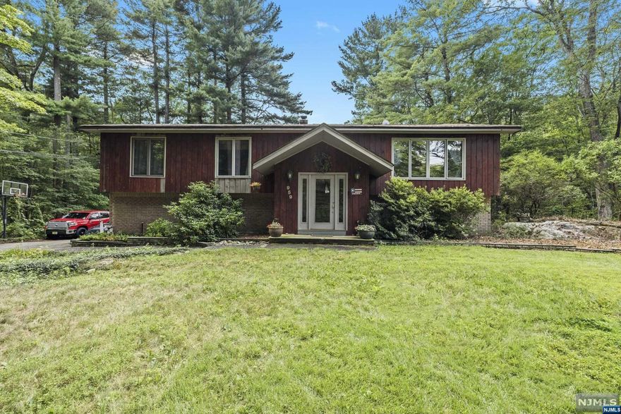 2,300 sq ft home nestled in nature! 1.55 acres with view of Kitchell Lake. Wood floors, central air, 3 zone hot water baseboard heating. Boiler 2022. Roof 2002.Generator hook-up w/transfer switches. Primary suite, two additional bedrooms, open floor plan. All large rooms - eat-in kitchen, dining room and living room. Living room with bay window, vaulted ceiling and lake view. Spacious lower level walk-out to patio and scenic yard. Lower level includes tremendous recreation and family room with access to covered patio, powder room, den/office, laundry, utility and entrance to over-sized garage. Minutes to shopping, restaurants and major highways. 36 miles to NYC and 8 miles to beautiful Greenwood Lake. Pre-approved buyers only.