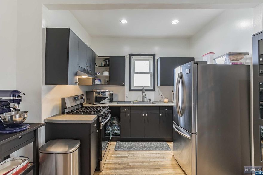 Welcome to 46 Jewell Street in Garfield! This wonderful property is situated on the corner of Jewell Street and Columbus Ave and has a house address of 41 Columbus Avenue. The property is on a large corner lot and as such has a large side yard, a detached garage and off street parking. Once you enter this property you will immediately be greeted by lots of natural sunlight and a property that was fully updated and renovated, most of it done in 2022. Downstairs is an updated eat-in-kitchen updated in 2018 with recessed lighting, a separate dining room, a family room and a 1/2 bathroom. The second floor has a full updated bathroom, 2 bedrooms and a 3rd room which could be a 4th bedroom. The 3rd floor was completely renovated and is the 3rd bedroom that is its own private oasis and includes recessed lighting as well. All the floors are either hardwood or laminate throughout. The basement is unfinished but has high ceilings and is perfect for a gym. Make this one your home!