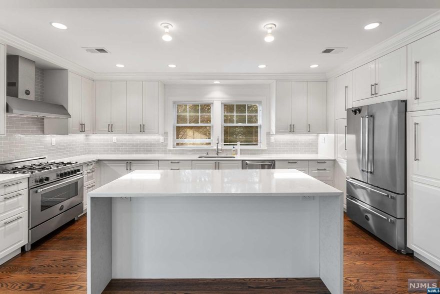 Beautiful and spacious colonial home in the prime Wyoming section of Millburn. Newly renovated and extended in 2018. Featuring oak hardwood floors throughout, central air and heat, 6 bedrooms and 5 full bathrooms, a huge eat in kitchen with white shaker solid wood cabinets, quartz counter tops, center island, stainless-steel appliances, with access to the deck that is overlooking the beautifully landscaped backyard. Also, on main floor includes a formal dining room, living room with a wood-burning fireplace, and a full bathroom. The 2nd floor boasts 3 bedrooms a full bath plus nice size master-suite with a walk-in closet, 2 extra closets, a master bath with 2 separate vanities, deep sunk in tub and shower. On 3rd level you have 2 additional rooms and a full bathroom. The basement is completely finished with 8ft high ceilings, a large room that can used as a family, playroom or for entertaining your guest, an additional bedroom, full bathroom, laundry room and utilities room.